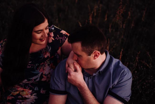 Man kissing his partner's hand during a couples photography session at Perry's Paddock, Perth