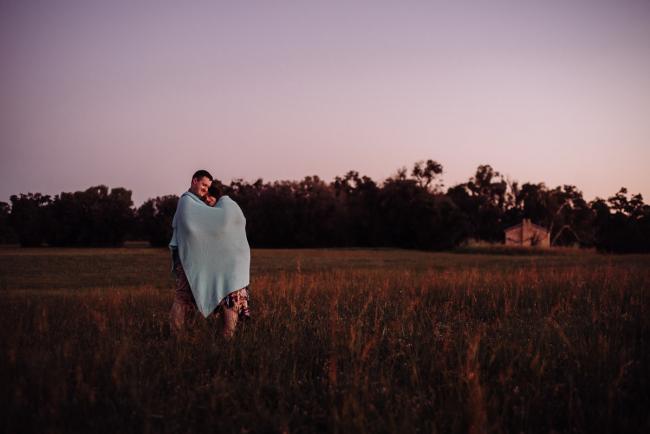 Couple embracing with a blanket around them during a couples photography session at Perry's Paddock, Perth