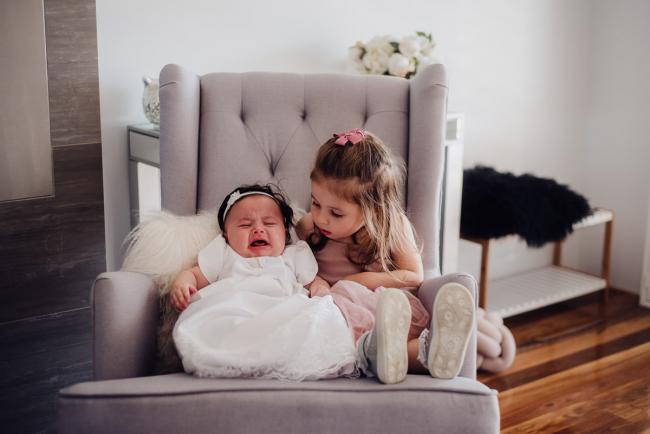 20180930-DSC_9449 Little girl sitting on a chair next to her crying baby sister during events photography Perth session