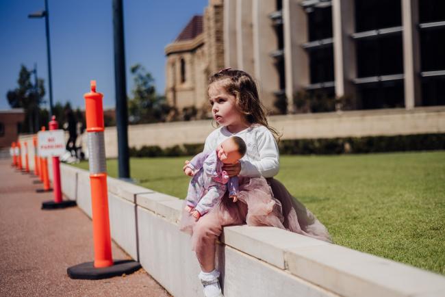 20180930-DSC_9742 little girl sits on a wall with her doll during events photography Perth session