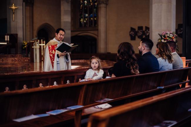 20180930-DSC_9862 Little girl sits in the pews of the church looking back during events photography Perth session