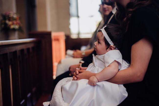 20180930-DSC_9875 baby sits on her mothers lap during Christening ceremony during events photography Perth session