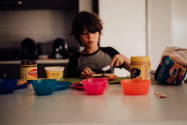 Boy making breakfast by family photographer perth