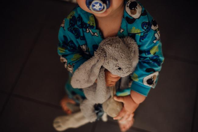 Little boy holding onto his bunnies by family photographer perth