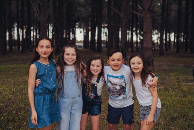 20181005-DSC_0413 Cousins standing with arms around each other during Perth family photography session at The Pines Wanneroo