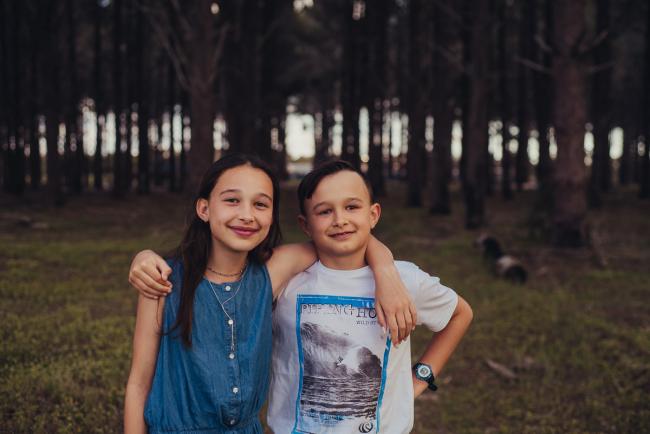 20181005-DSC_0426 Brother and sister with their arms around each other during Perth family photography session at The Pines Wanneroo