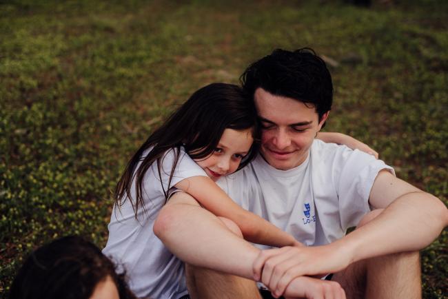 20181005-DSC_0510 Little sister cuddling her big brother during Perth family photography session at The Pines Wanneroo