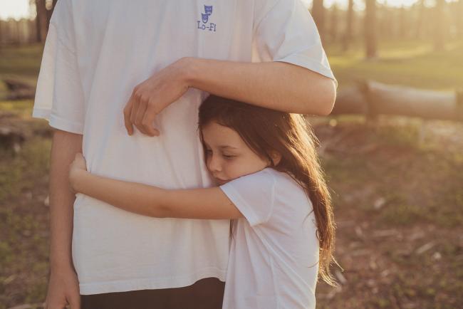 20181005-DSC_0963 Little sister wrapping her arms around big brothers tummy during Perth family photography session at The Pines Wanneroo