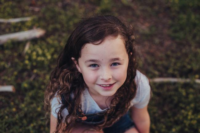 20181005-DSC_1371 Girl smiling at the camera during Perth family photography session at The Pines Wanneroo