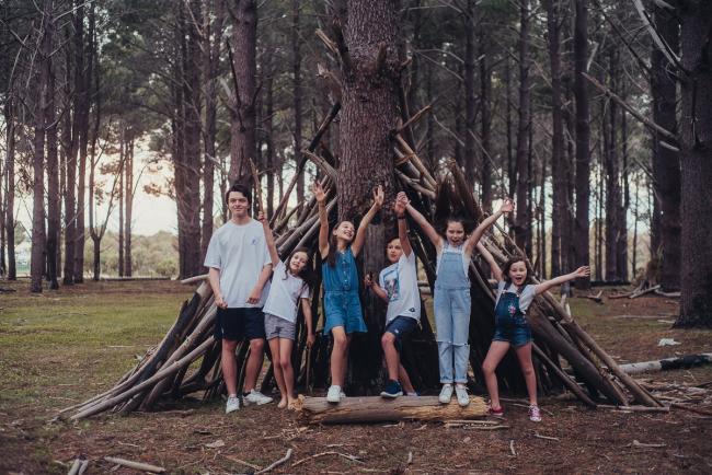 20181005-DSC_1441 Cousins throwing arms in the air during Perth family photography session at The Pines Wanneroo