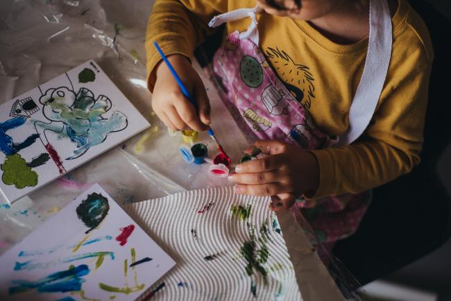 Top down shot of little boy and his paints with family photographer in Perth