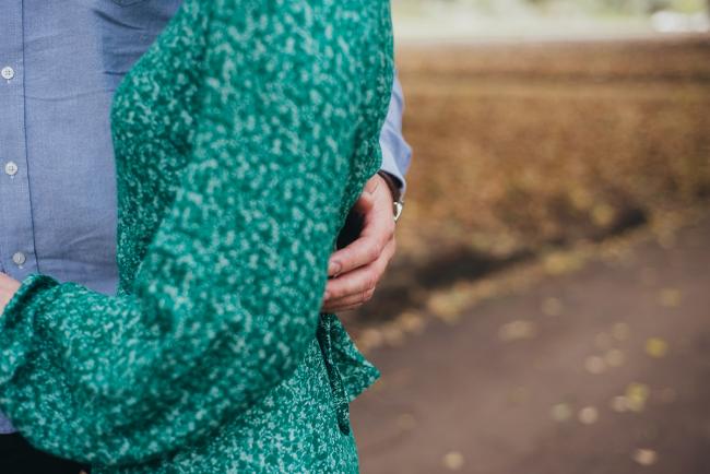 Man with his arm around his wife during a family photography session at Hyde Park in Perth