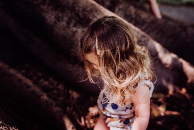 Little girl looking down during a mini session with Perth family photographer at Hyde Park