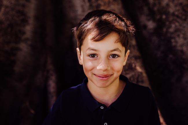 Little boy smiling during a mini session with Perth family photographer at Hyde Park