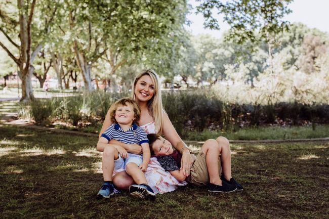 20181104-DSC_6986 Mother sitting with her two sons on her lap during a mini session with Perth family photographer at Hyde Park