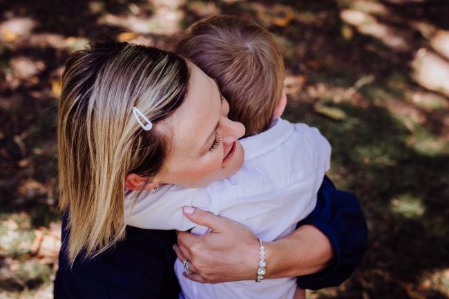 Little boy hugging his mother during a mini session with Perth family photographer at Hyde Park