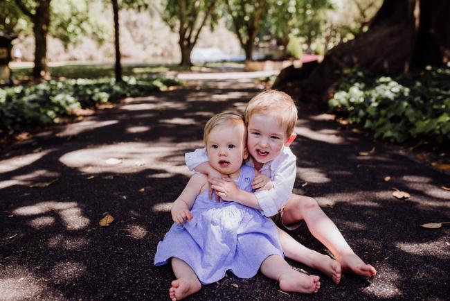 Little boy hugging his little sister during a mini session with Perth family photographer at Hyde Park