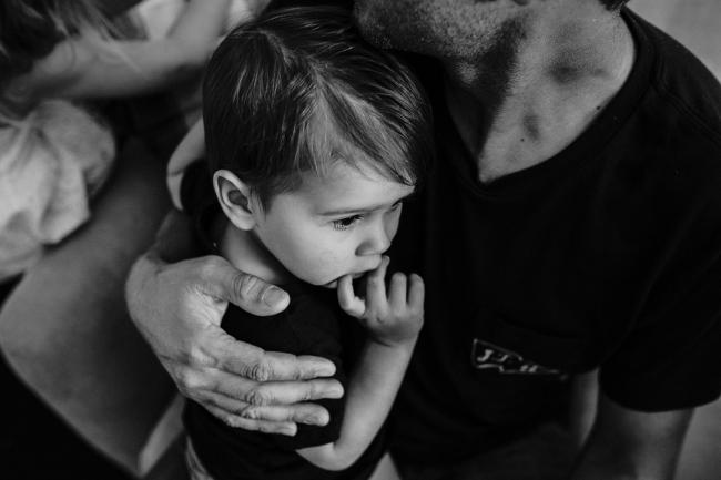 20181111-DSC_8064-1 black and white image of a toddler cuddled into his father in a lifestyle family photography session Perth