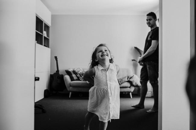 20181111-DSC_8319-1 black and white image of a little girl running towards the camera in a lifestyle family photography session Perth