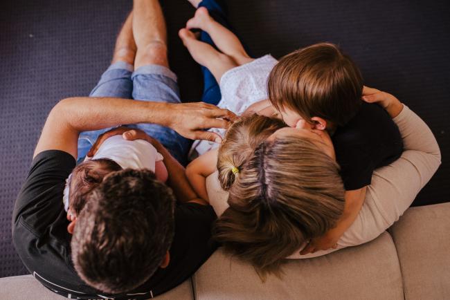 20181111-DSC_8461-1 top down shot of parents sitting on the floor hugging their 3 children in a lifestyle family photography session Perth