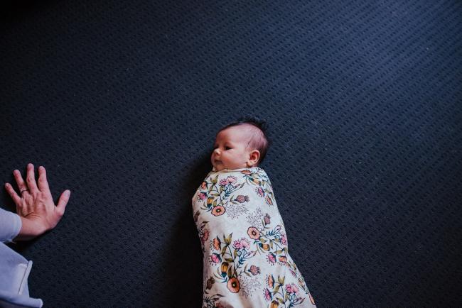 20181111-DSC_8669-2 New baby wrapped in a floral blanket on the floor in a lifestyle family photography session Perth
