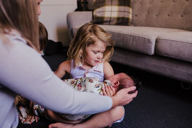 20181111-DSC_8707-2 Big sister holding her new baby sister in a lifestyle family photography session Perth