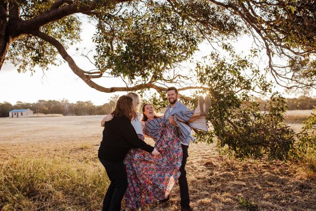 Siblings lifting up their sister during golden hour family photography session at Perry's Paddock Perth