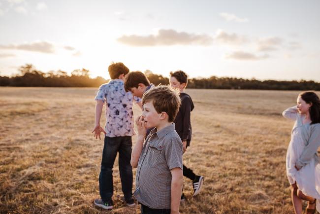 Cousins in a field during golden hour family photography session at Perry's Paddock Perth