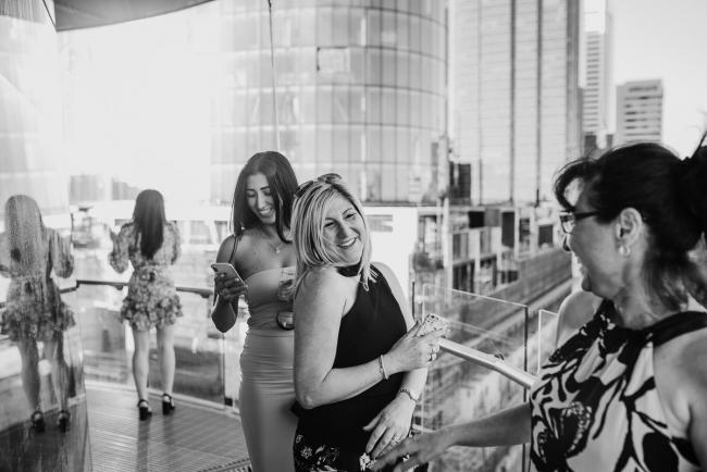 20181202-DSC_2684 Black and white image of women laughing during Perth events photography session at The Bell Tower Perth