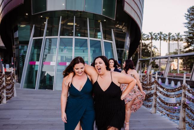20181202-DSC_2836 Women laughing as they walk outside during Perth events photography session at The Bell Tower Perth