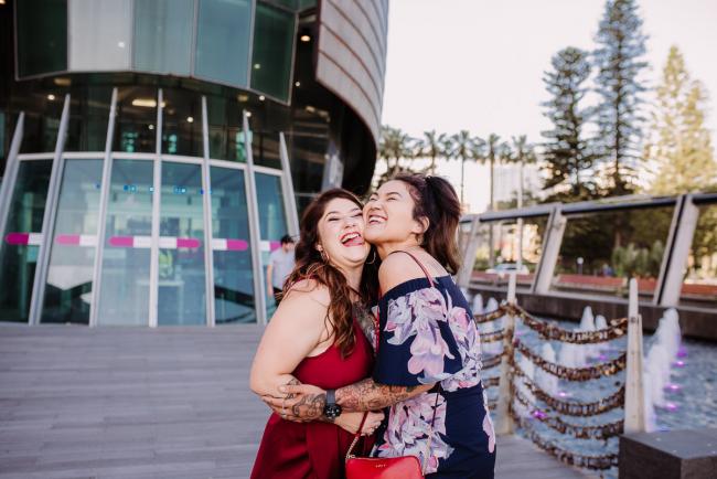 20181202-DSC_2846 Women hugging and laughing during Perth events photography session at The Bell Tower Perth