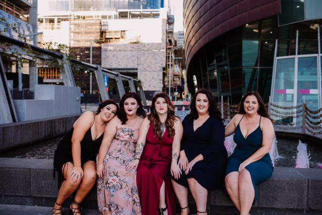 20181202-DSC_2874 Woman and her bridesmaids sitting on a wall during Perth events photography session at The Bell Tower Perth
