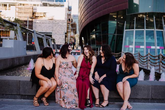 20181202-DSC_2877 Woman and her bridesmaids sitting on a wall during Perth events photography session at The Bell Tower Perth