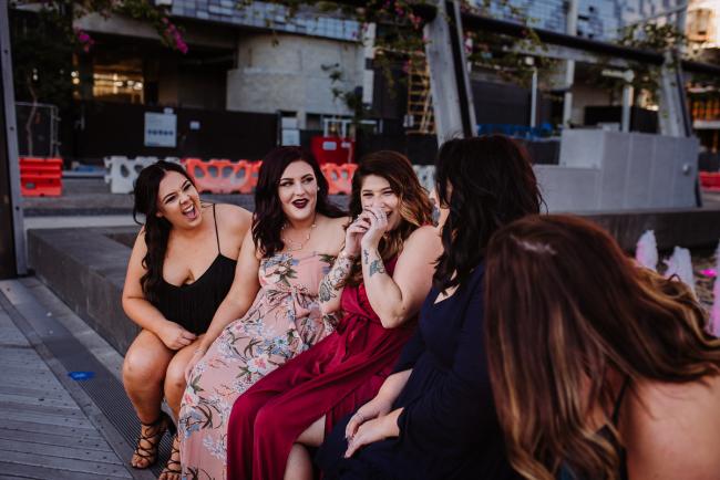 20181202-DSC_2900 Women laughing on a wall during Perth events photography session at The Bell Tower Perth