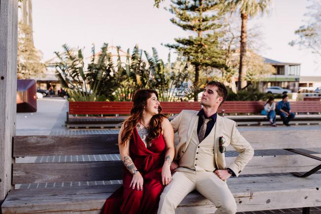 20181202-DSC_3035 Couple sitting on a wooden bench during Perth events photography session at The Bell Tower Perth