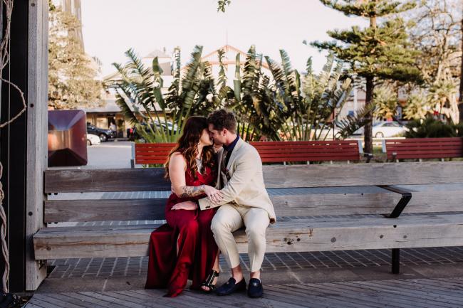 20181202-DSC_3054 Couple kissing on a bench during Perth events photography session at The Bell Tower Perth