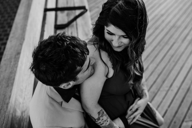 20181202-DSC_3072 Black and white image of woman sitting on man's lap during Perth events photography session at The Bell Tower Perth