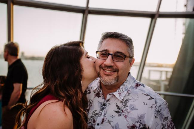 20181202-DSC_3420 Woman kissing her father during Perth events photography session at The Bell Tower Perth