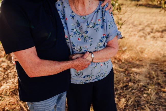 Older couple holding hands during an extended family photography session at Perry's Paddock in Perth