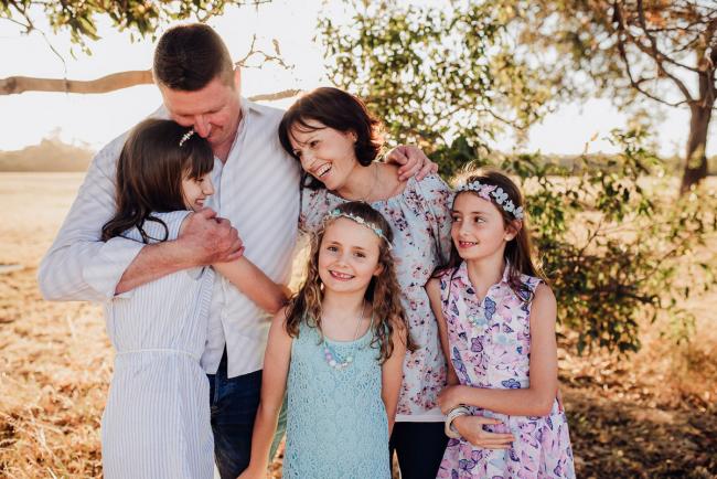 Family of 5 standing and hugging during an extended family photography session at Perry's Paddock in Perth