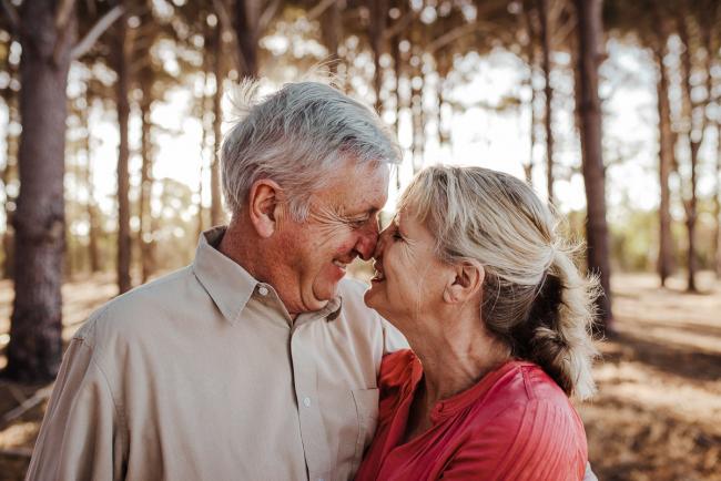 Couple touching noses during an extended family photography session at The Pines Wanneroo in Perth
