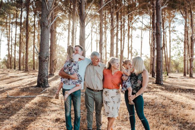 Grandparents and their daughter and grandchildren during an extended family photography session at The Pines Wanneroo in Perth