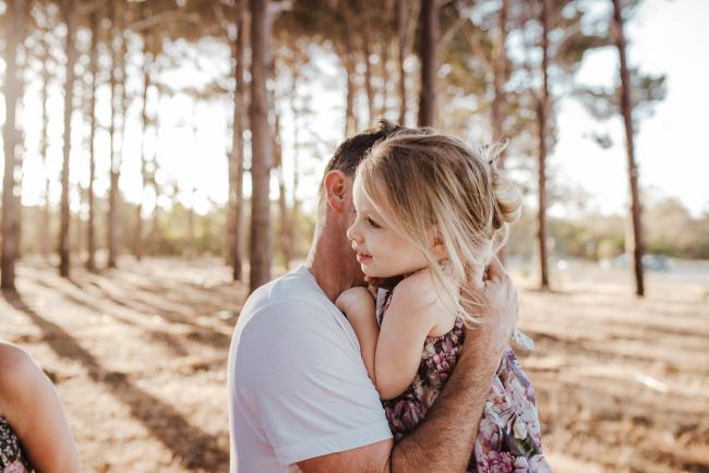 Father and daughter hugging during an extended family photography session at The Pines Wanneroo in Perth