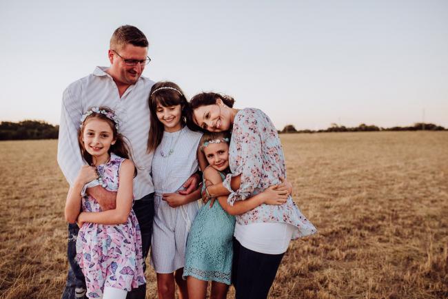 Family of 5 hugging during an extended family photography session at Perry's Paddock in Perth