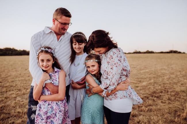 Family hugging during an extended family photography session at Perry's Paddock in Perth