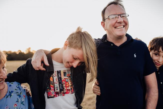 Father with his arm around his son during an extended family photography session at Perry's Paddock in Perth