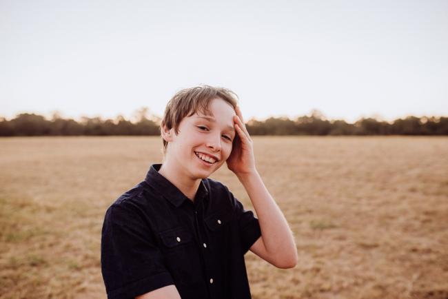 Boy laughing during an extended family photography session at Perry's Paddock in Perth