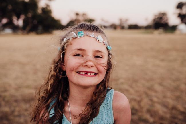 Little girl smiling during an extended family photography session at Perry's Paddock in Perth