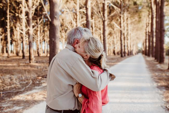 Couple hugging during an extended family photography session at The Pines Wanneroo in Perth