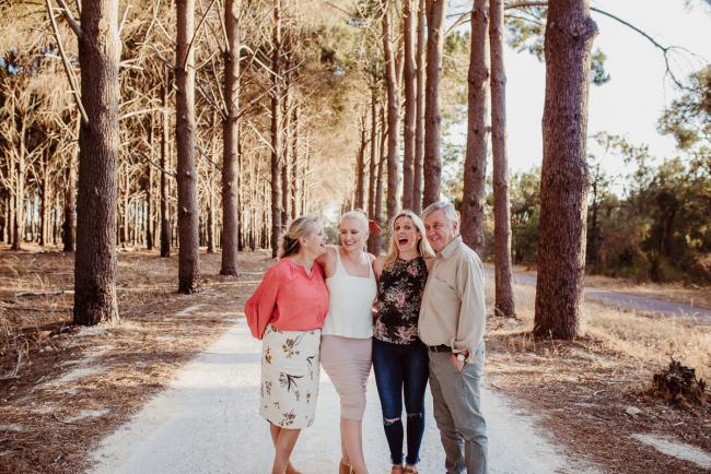 Parents and their grown daughters during an extended family photography session at The Pines Wanneroo in Perth